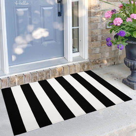 KILOCOCO black and white striped rug on a front porch, durable indoor/outdoor use.