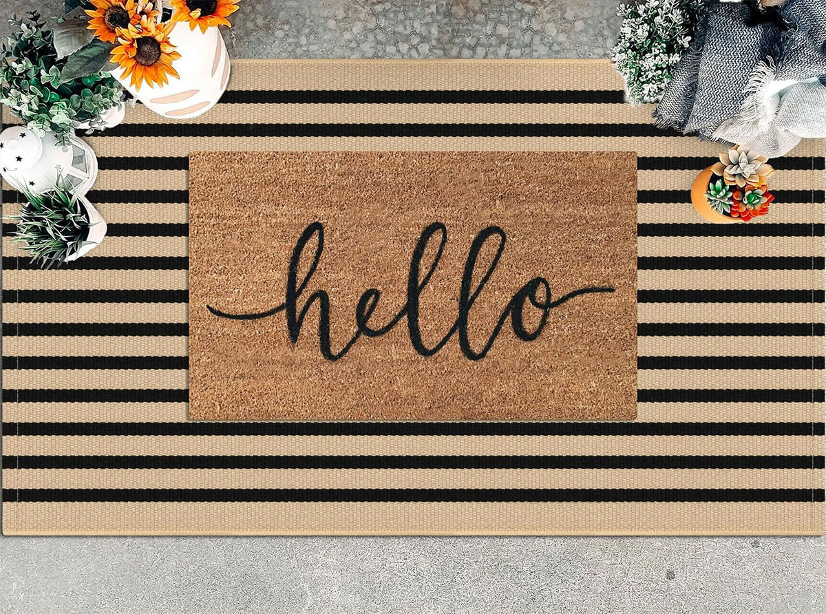 KILOCOCO brown-black striped rug on doorway adds warm, welcoming style.