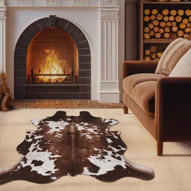 KINOGIC faux cowhide rug cow print enhances bedroom decor with soft texture.