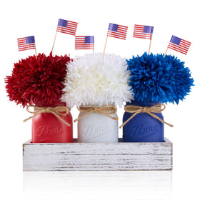 KIVIVO Fourth of July mason jar centerpiece with red, white and blue accents.