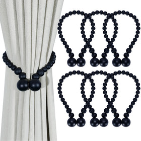 KLOGTSIND magnetic curtain tiebacks with wood beads securely holding curtains in a boho style.