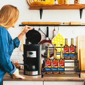 Klxuyuo coffee syrup rack showing rustic wood base and organized shelves.