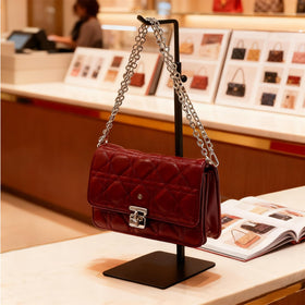 KMtilsh purse display stand in boutique setting presents bags with polished, professional flair