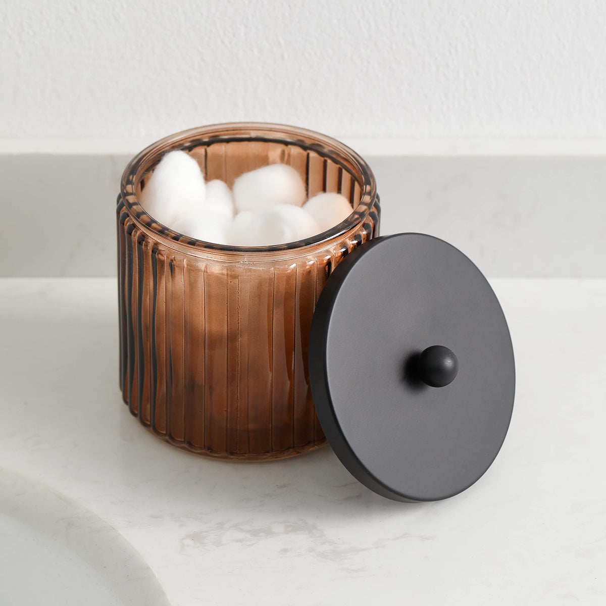 Clear brown glass shows contents at a glance inside KMwares storage canister.