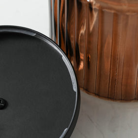 Stylish bathroom display combining brown glass with matte lids.