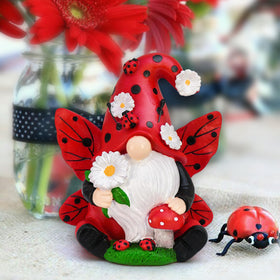 KnomeKo fairy gnome with wings and daisies brightening a corner