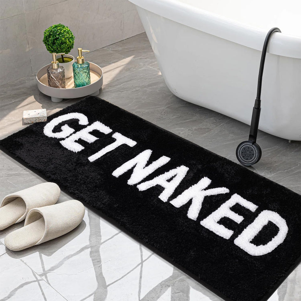 KOEXM Get Naked bath mat with 3D lettering enhances bathroom decor