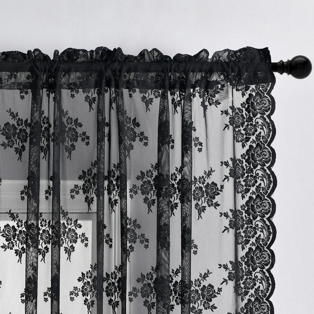 Kotile black lace curtains frame a window with elegant silhouette