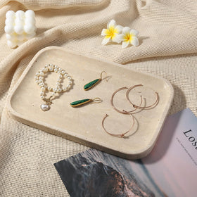 Koville Travertine Tray with rectangle edge containing small items securely