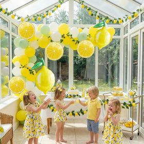 Kozee lemon slice balloon in yellow boosts cheerful table decor.