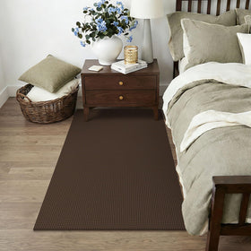KOZYFLY flat low-profile rug sits neatly under a door