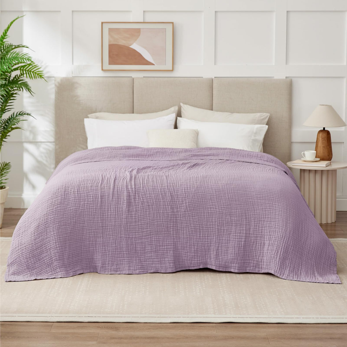 Kozyhvn blanket in a cozy bedroom setting, suggesting all-season comfort.
