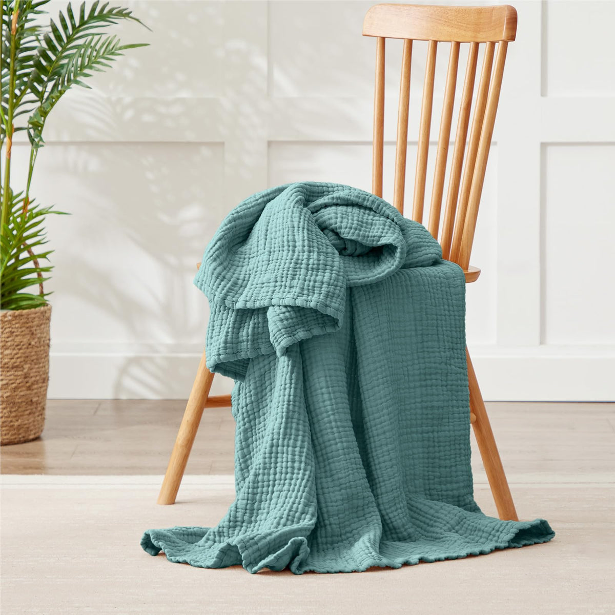 Kozyhvn blanket teal on bed and couch for versatile lounging and décor
