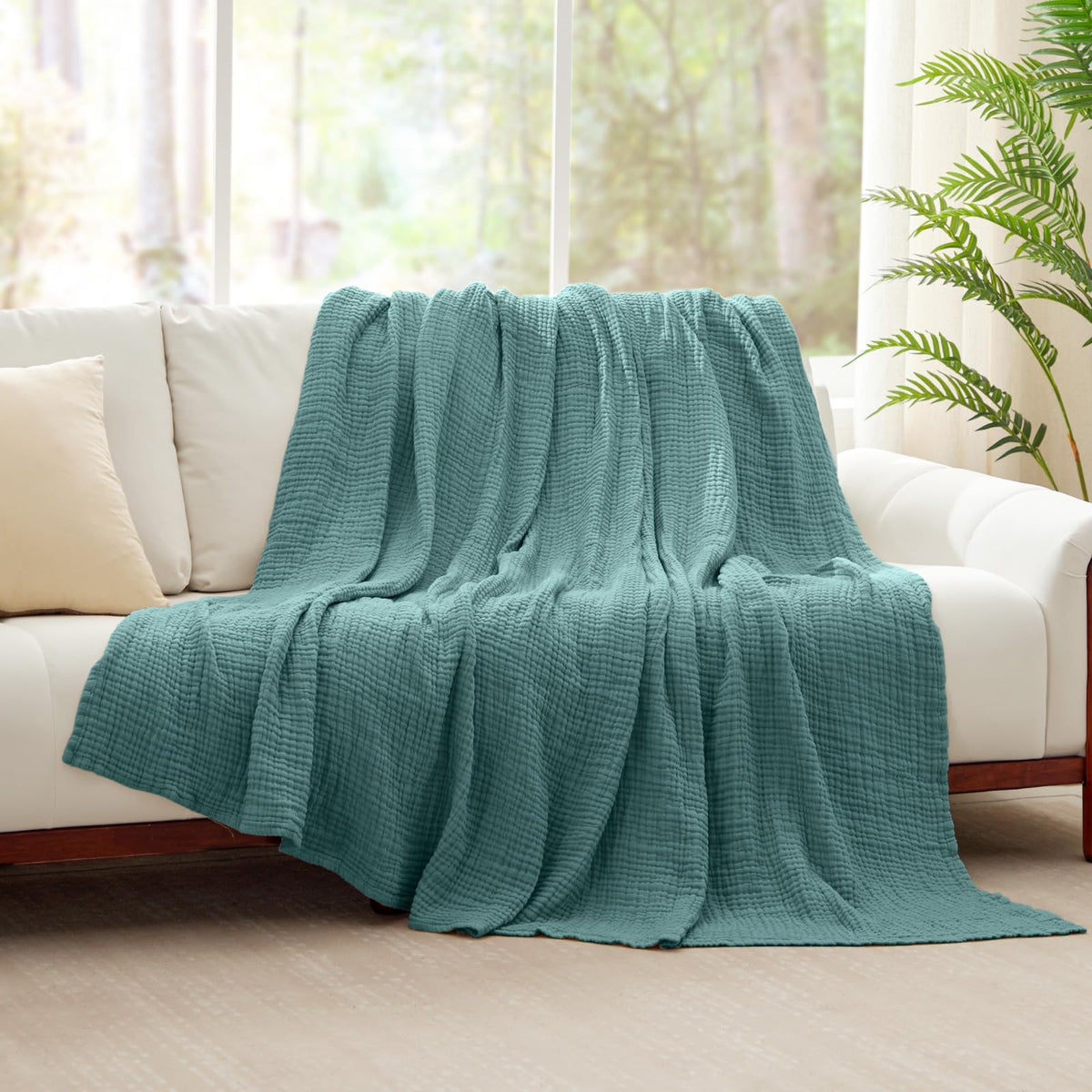 Kozyhvn teal muslin throw folded for travel and on-the-go warmth