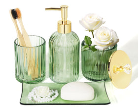 Kukikan designer green glass dispenser enhances bathroom organization.