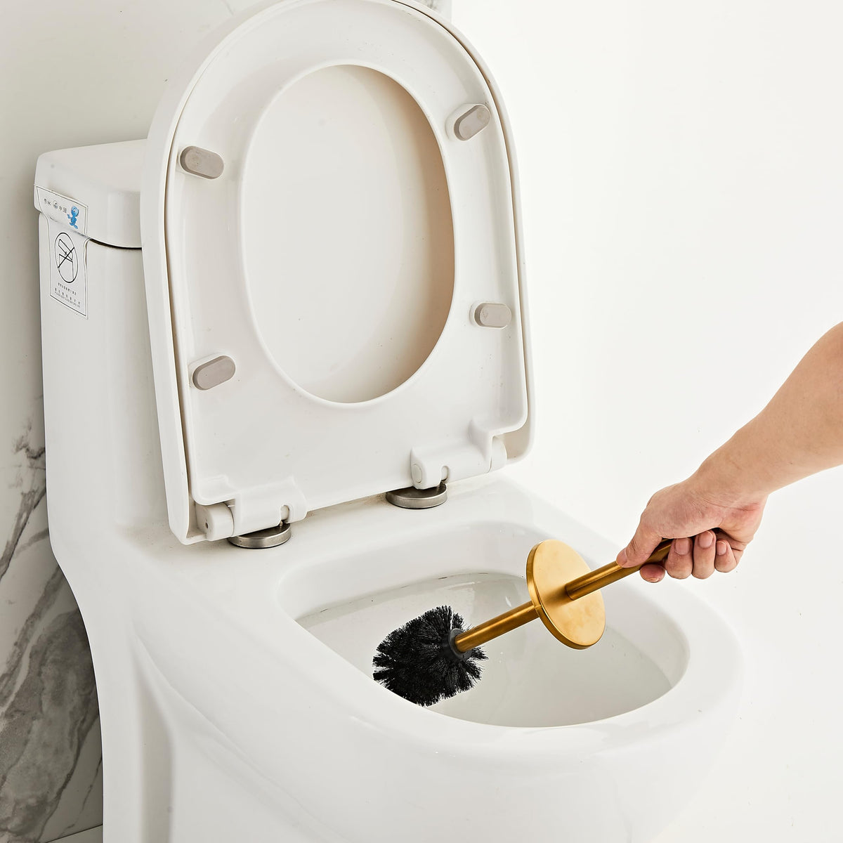 KUUBTH brushed-gold holder with brush showcases discreet bathroom storage