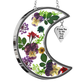 KY&BOSAM moon suncatcher with pressed flowers inside glass, catching morning light