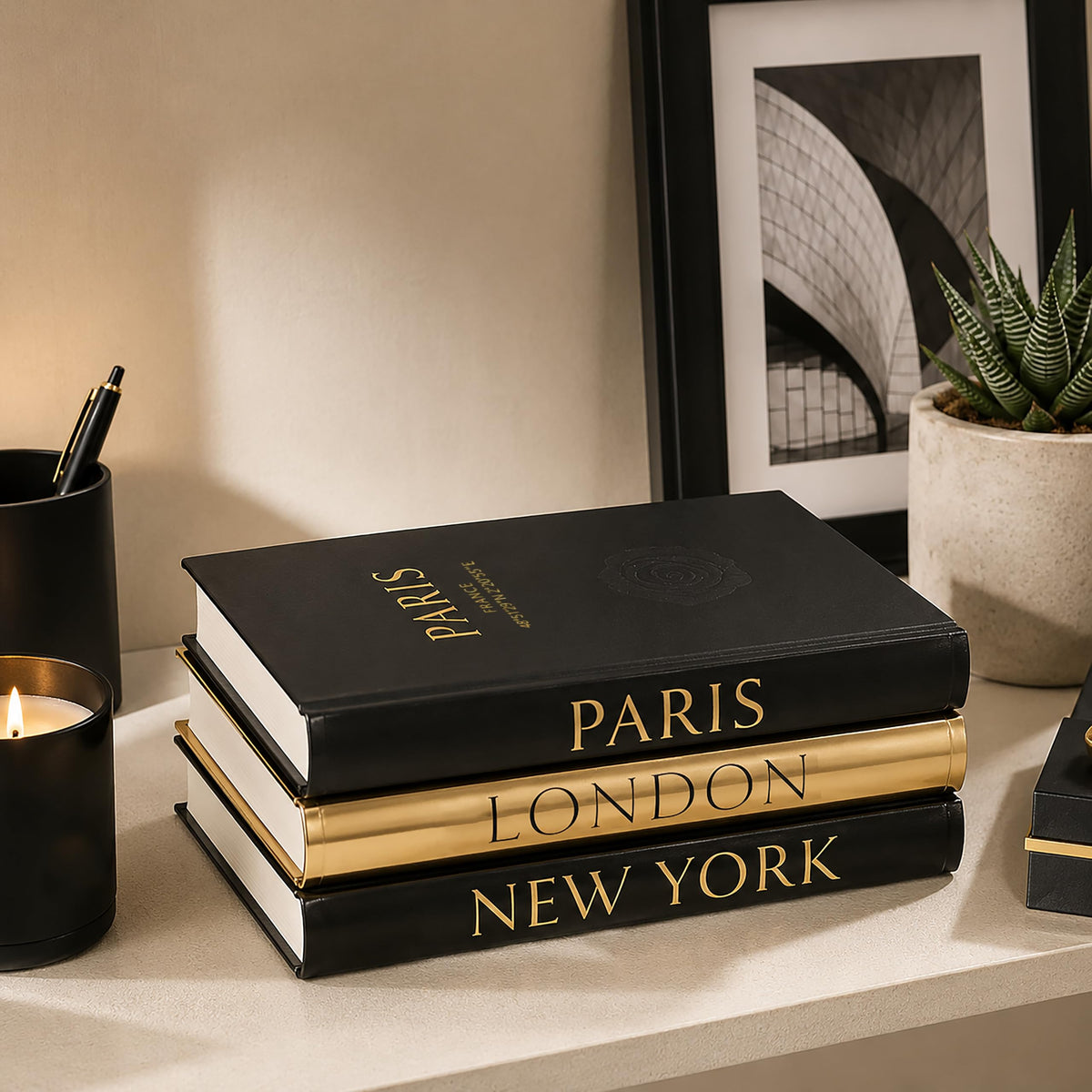 L’AMOUR HOME DECOR black and gold foil books on a shelf elevate style.