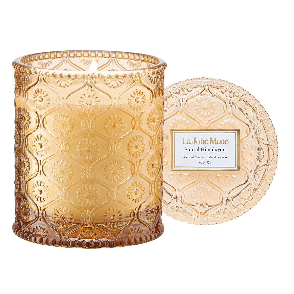 LA JOLIE MUSE amber-sandalwood candle in embossed jar for elegant ambiance.