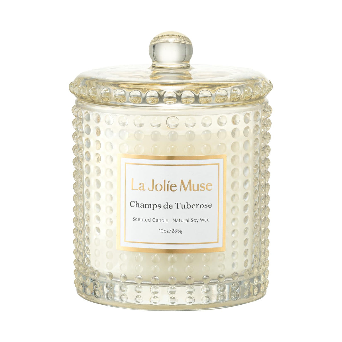 LA JOLIE MUSE Champs de Tuberose candle in glass jar enhances ambiance with a decorative hobnail glow.