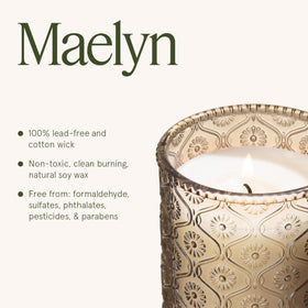 LA JOLIE MUSE decorative embossed jar on a table adds elegance.