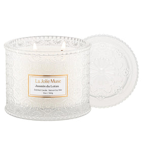 LA JOLIE MUSE Jasmin du Lotus candle in embossed jar adds elegant decor and fragrance.