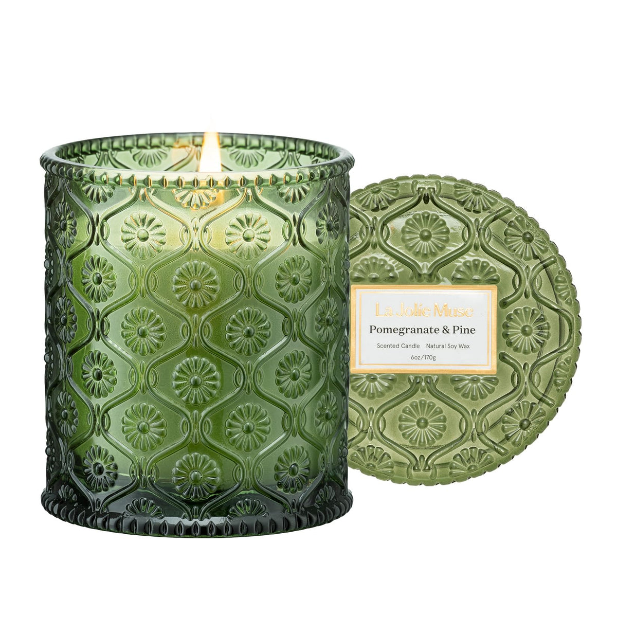 LA JOLIE MUSE Pine & Pomegranate candle in a daisy-embossed jar for festive ambience.