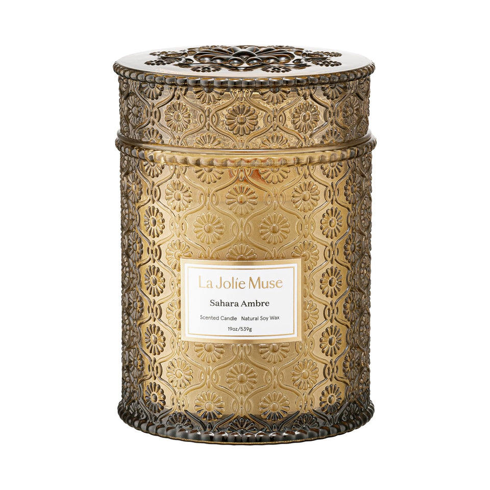 LA JOLIE MUSE Sahara Amber Candle embossed-daisy jar enhances cozy decor.