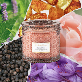 Close-up of embossed jar on LA JOLIE MUSE Santal Rosé candle elevating ambiance.