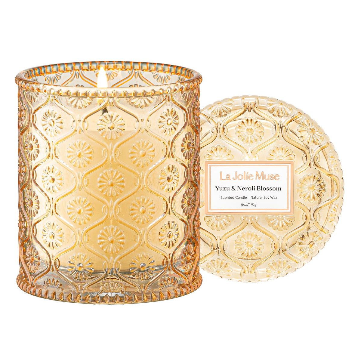 LA JOLIE MUSE Yuzu & Neroli Blossom candle jar with daisy pattern creates chic ambiance.