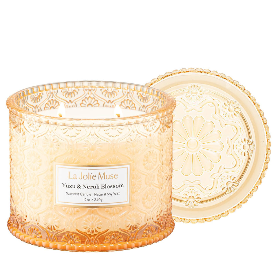 LA JOLIE MUSE Yuzu & Neroli Candle jar with embossed daisy motif for elegant décor.