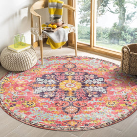 Lahome round rug with bohemian floral medallion in hot pink creates cozy bedroom ambiance