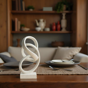 Laikearts white ribbon sculpture on a coffee table acts as a design anchor
