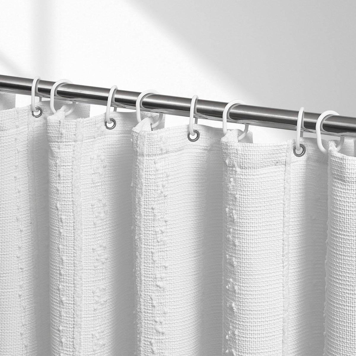 Lameirose white shower curtain closeup of waffle texture and stripe detailing for a stylish bath.