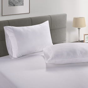 Lane Linen hotel-quality feel conveyed by pristine white bedding on bed
