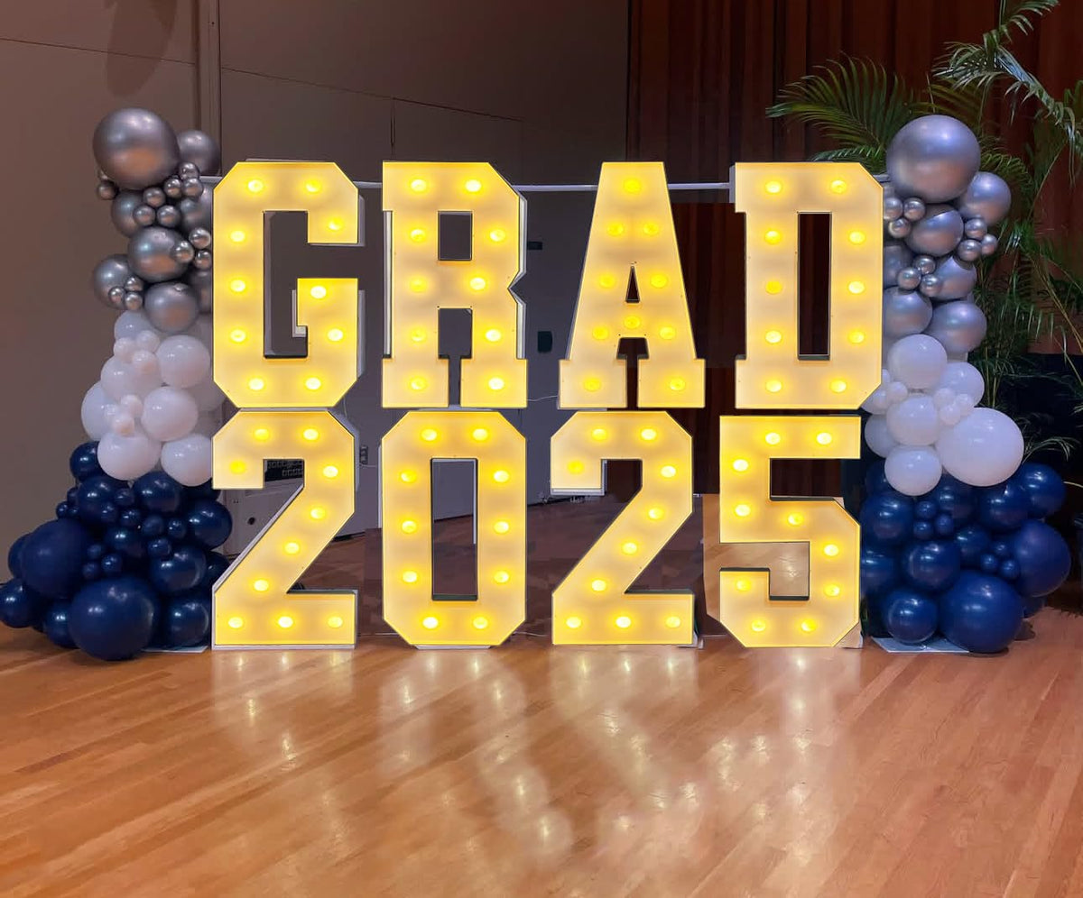 LANGXUN photo backdrop displays a dramatic graduation setup with illuminated letters.