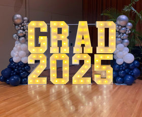 LANGXUN photo backdrop displays a dramatic graduation setup with illuminated letters.