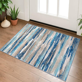 Lansny small abstract rug in aqua and beige tones adds soft, non-slip comfort to entryways