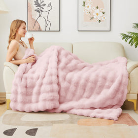 Latepis pink faux fur throw in bed showcases luxurious warmth for all seasons.
