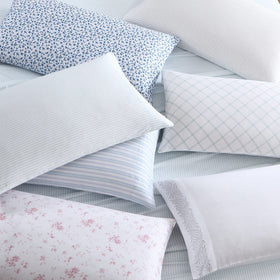 Pillowcase on a neatly made bed with Ramona Blue tones.