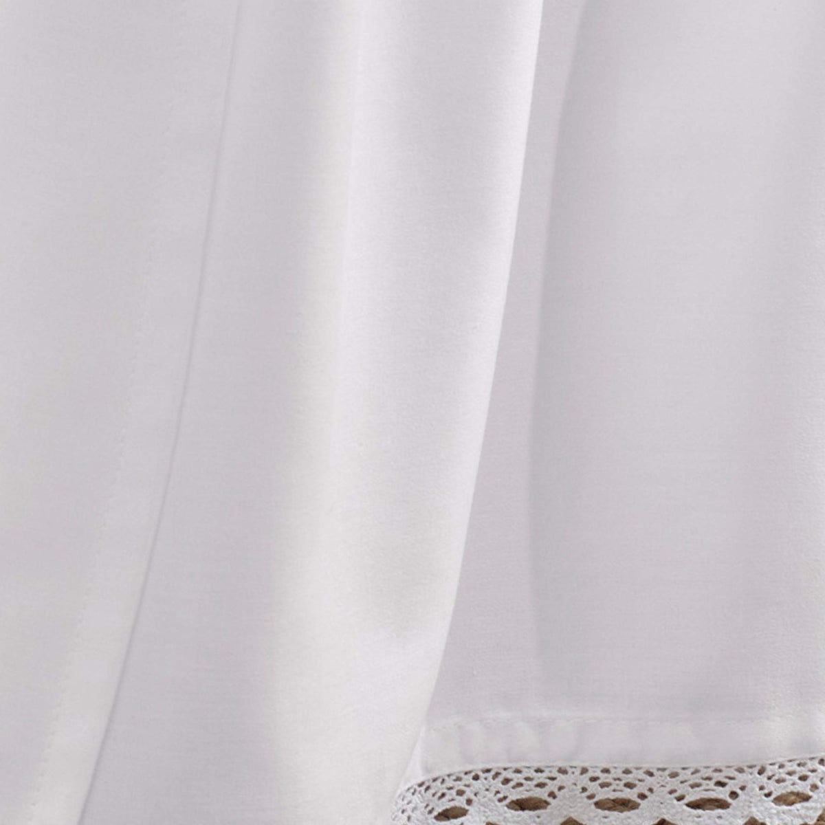 White bed skirt from Laura Ashley complements dorm decor with classic charm