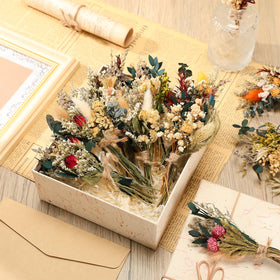 Layhit boho wedding decor idea with dried bouquets on rustic surface