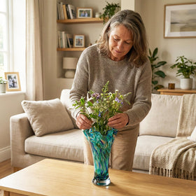 LCCCK teal glass vase as a centerpiece for living room décor.