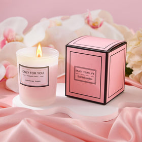LE CADEAU rose-scented candle creating a relaxing spa ambiance