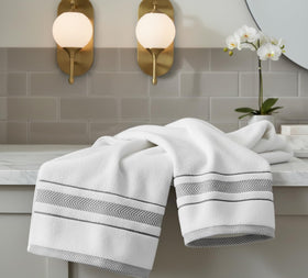 Le fil blanc washcloths neatly stacked for guest rooms