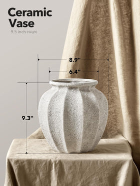 LE TAUCI weighted-base ceramic vase keeping tall stems secure for dramatic arrangements.