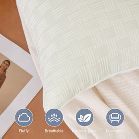 Leeden pillows feature elegant gray piping for a refined finish.