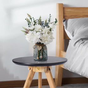 Leftover artificial flowers in vase—perfect for dining table decor.