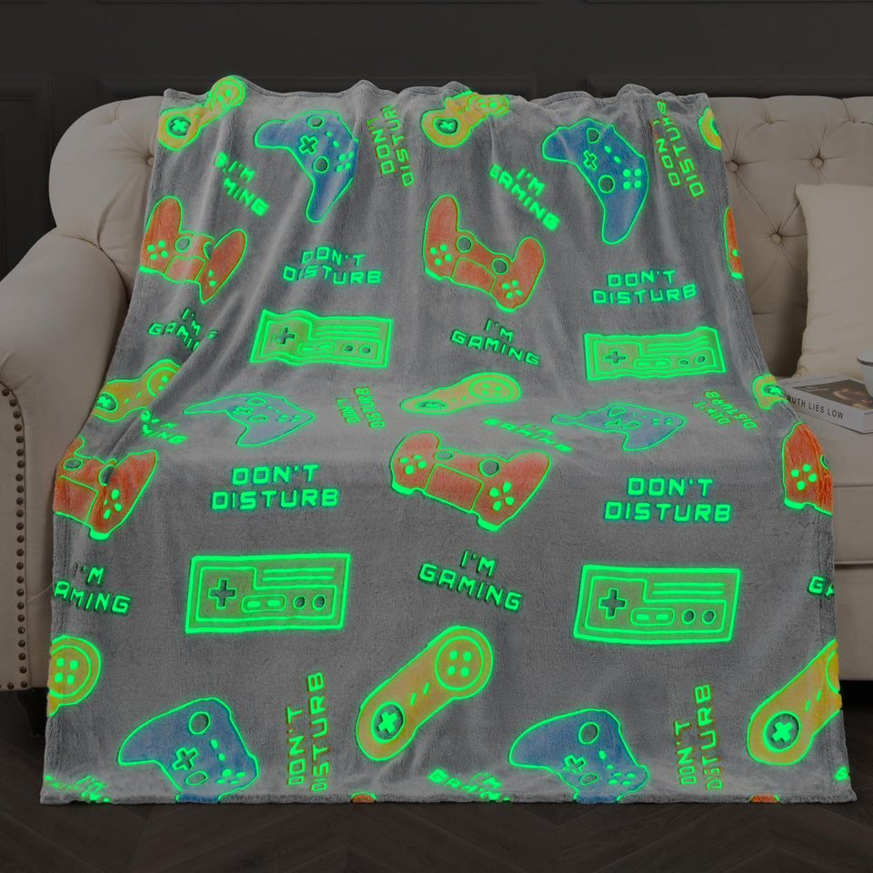 Levens gaming blanket glows in the dark with a gamepad pattern for kids.