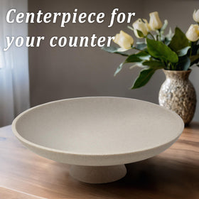 LIN CHUAN beige resin bowl on a pedestal highlights texture in a close-up view.